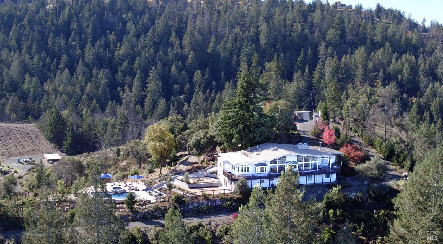 1755 Diamond Mountain Road Calistoga, CA 94515 - Photo 2 of 67 a view of a table and chairs under an umbrella