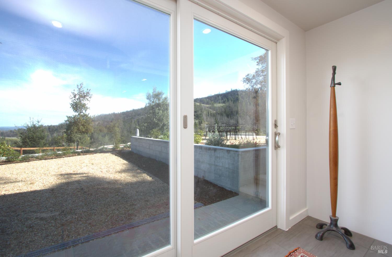 1755 Diamond Mountain Road Calistoga, CA 94515 - Photo 24 of 67 a view of a room with a floor to ceiling window and a yard
