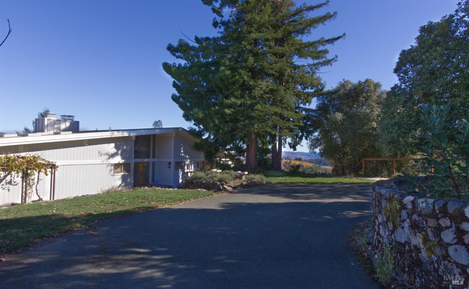 1755 Diamond Mountain Road Calistoga, CA 94515 - Photo 37 of 67 a view of a house with a yard and garage
