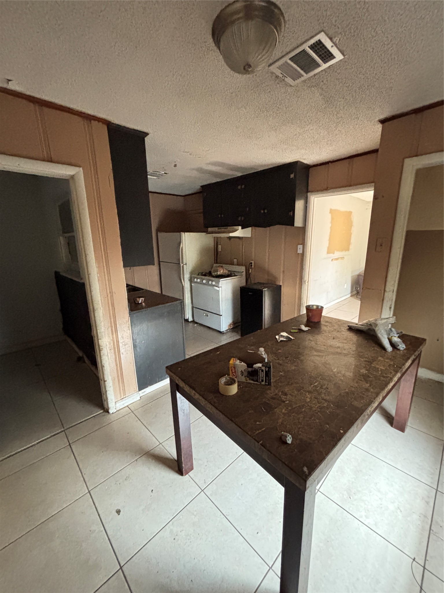 439 Terminal Street Houston, TX 77020 - Photo 4 of 7 a living room with stainless steel appliances furniture a rug and a view of kitchen