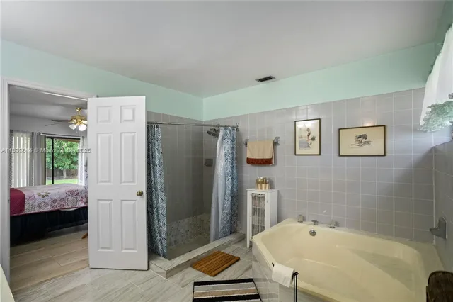 a bathroom with a tub and a shower