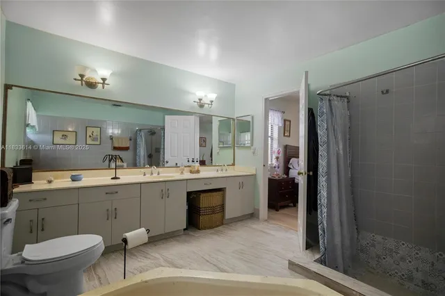 a bathroom with a sink toilet and shower