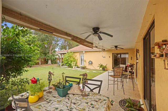 a view of a porch with furniture and garden view