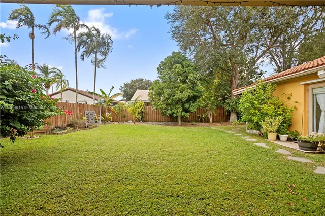 a view of a big yard with palm trees