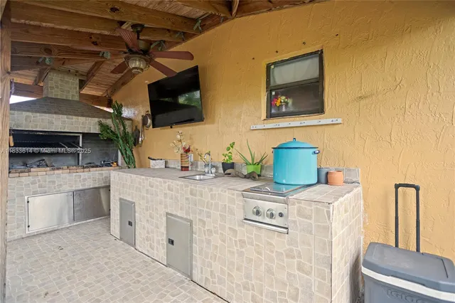 a kitchen with stainless steel appliances granite countertop a sink and a stove