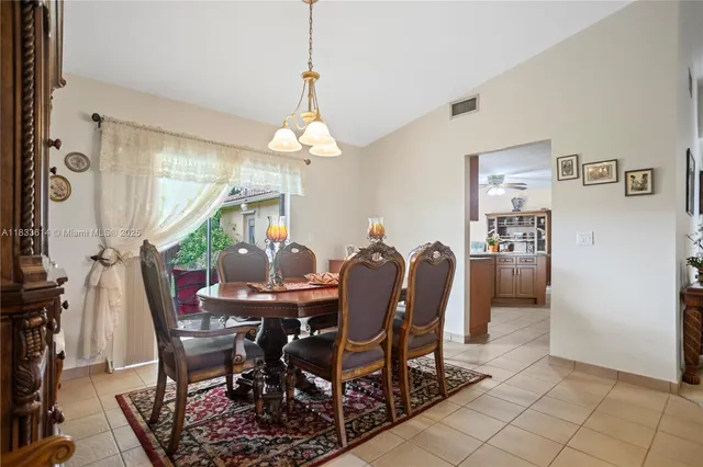 a view of a dining room with furniture and chandelier