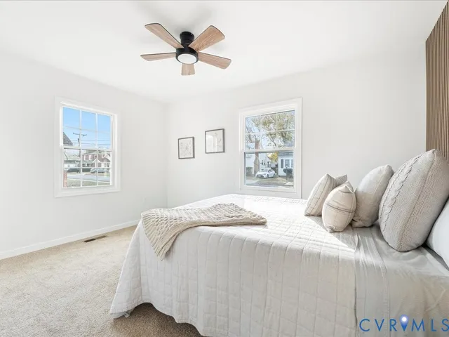 a bedroom with a large bed and a window