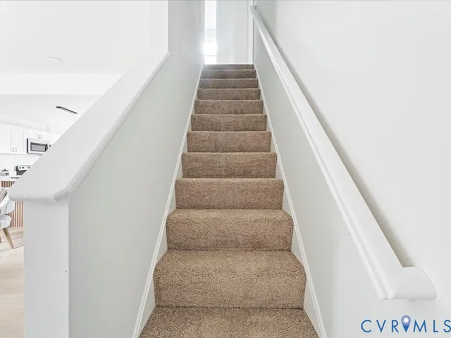 a view of staircase with white walls