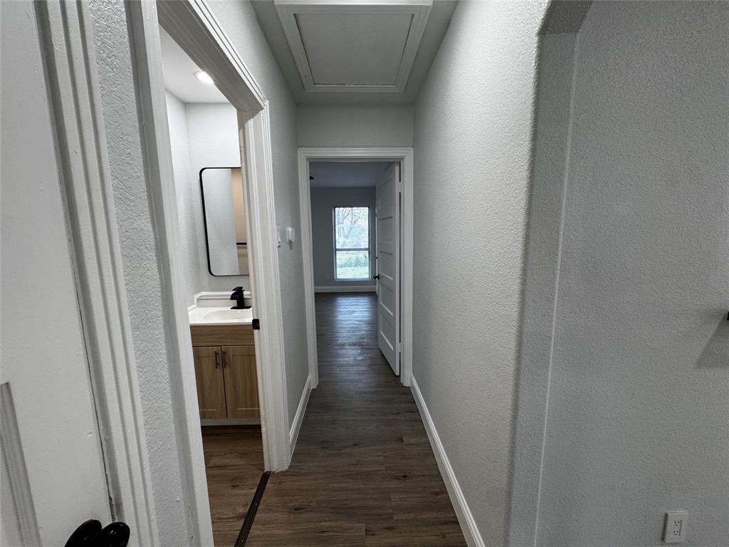 2909 Alexander Avenue Waco, TX 76708 - Photo 10 of 27 Corridor featuring a textured wall and dark wood-type flooring