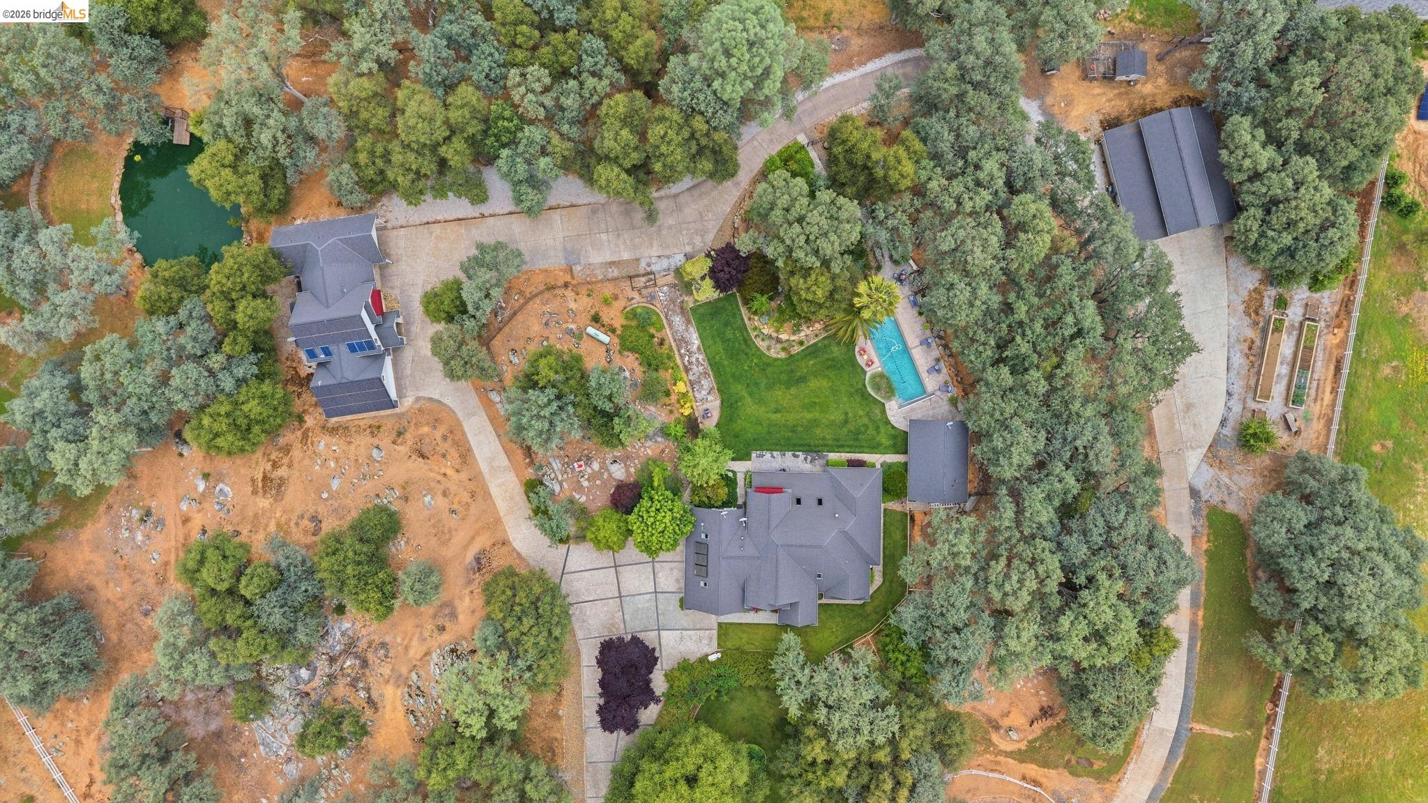 18450 Lambert Lake Road Sonora, CA 95370 - Photo 81 of 87 Expansive property featuring two residences, a swimming pool, a pond, and multiple outbuildings