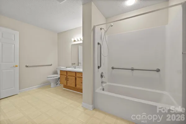 a view of an empty room with a ceiling fan