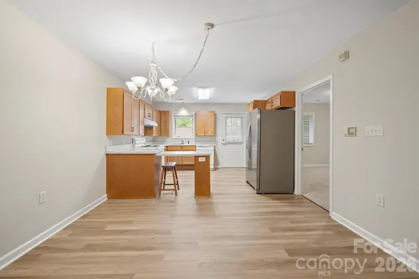 a kitchen with a stove a sink dishwasher and a refrigerator