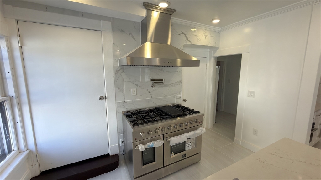 194 Sumner Avenue Springfield, MA 01108 - Photo 11 of 24 a kitchen with a stove and a refrigerator