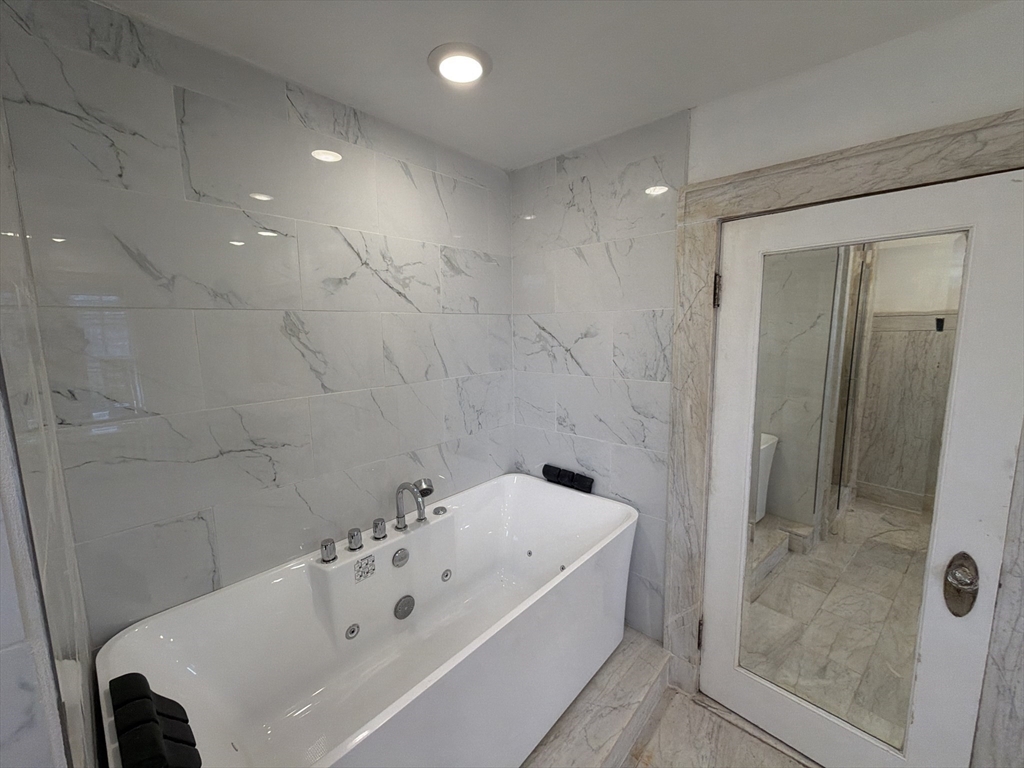 194 Sumner Avenue Springfield, MA 01108 - Photo 15 of 24 a bathroom with a bathtub and shower