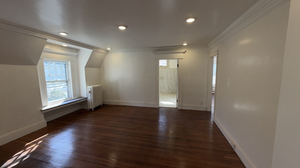 194 Sumner Avenue Springfield, MA 01108 - Photo 18 of 24 an empty room with wooden floor and windows