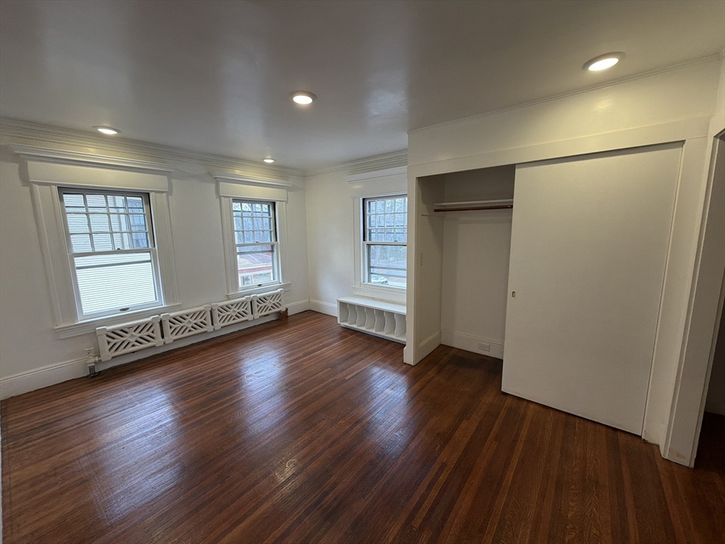 194 Sumner Avenue Springfield, MA 01108 - Photo 22 of 24 an empty room with wooden floor and windows