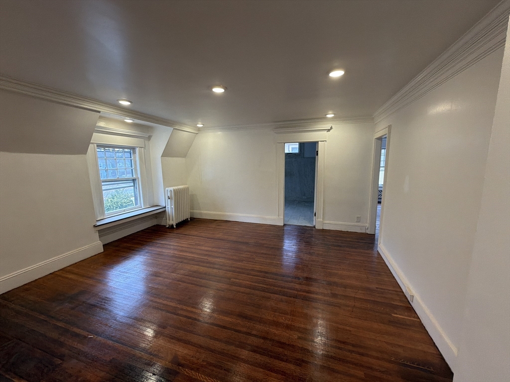 194 Sumner Avenue Springfield, MA 01108 - Photo 23 of 24 a view of a hallway with wooden floor