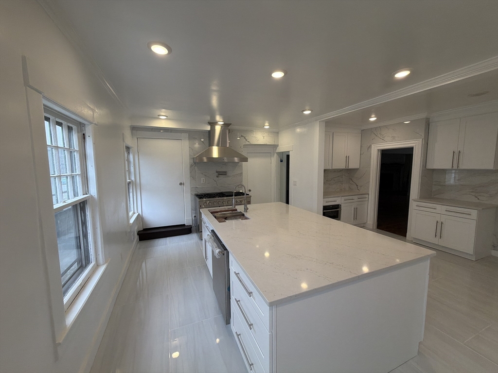 194 Sumner Avenue Springfield, MA 01108 - Photo 3 of 24 a large kitchen with stainless steel appliances kitchen island a stove a refrigerator a sink and a stove