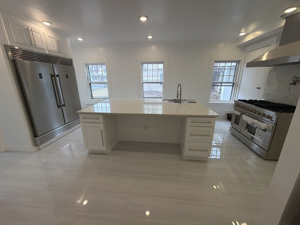 194 Sumner Avenue Springfield, MA 01108 - Photo 10 of 24 a kitchen with stainless steel appliances a refrigerator sink and stove