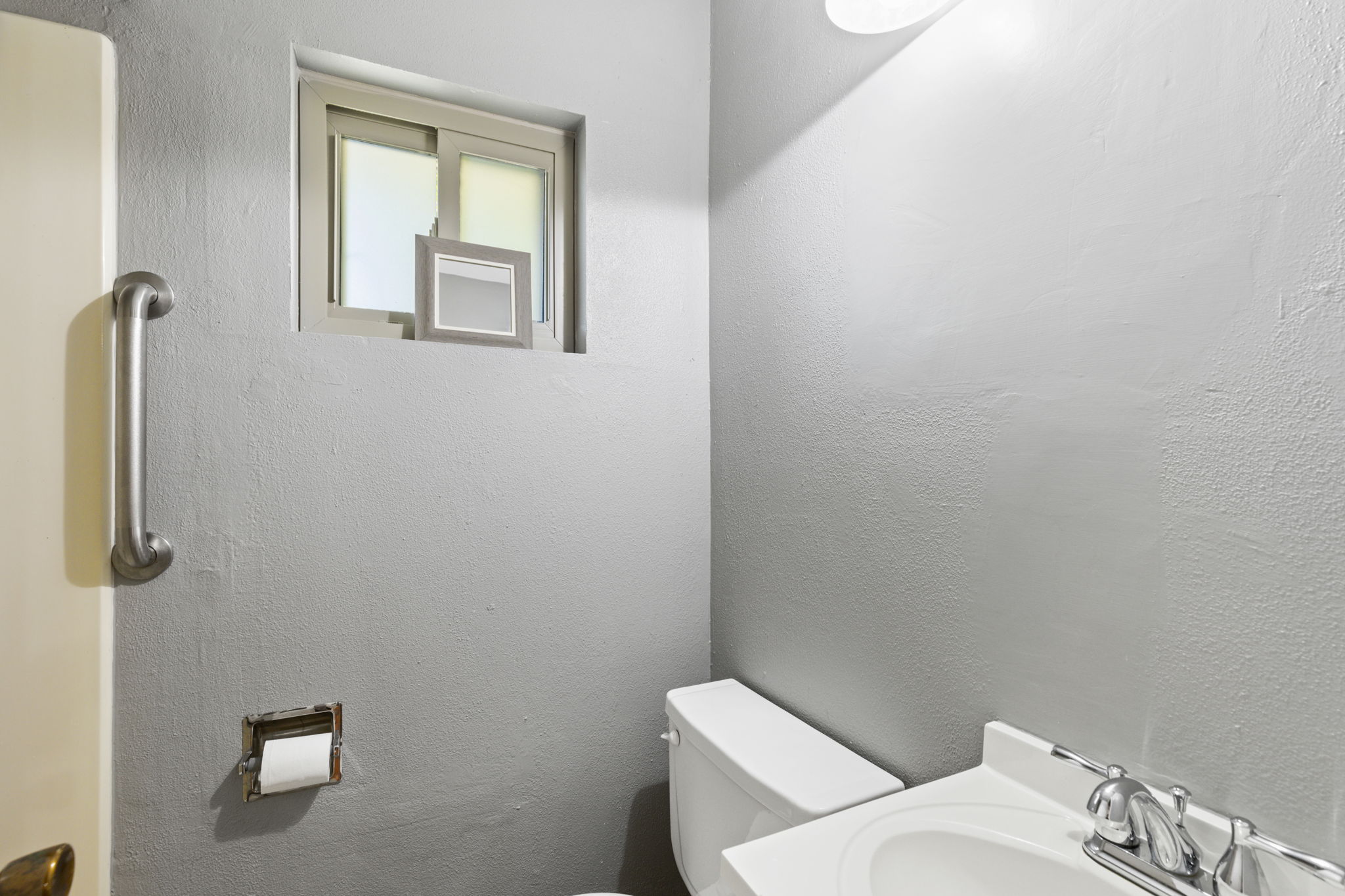 7808 Watson Street, Unit B Austin, TX 78757 - Photo 12 of 12 a white toilet sitting next to a bathroom sink