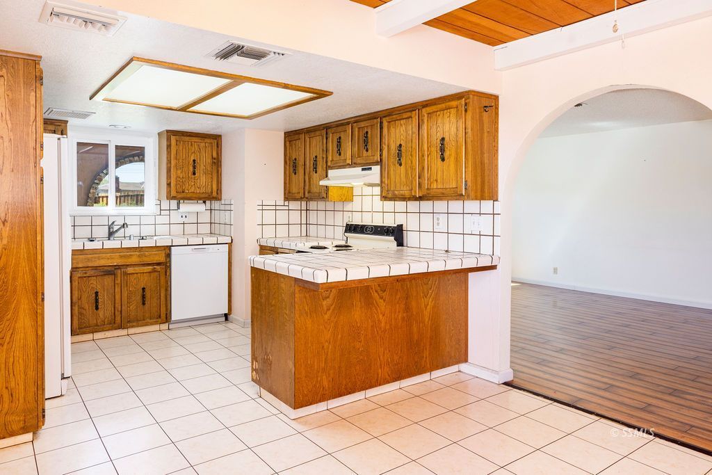 1144 West Benson Avenue Ridgecrest, CA 93555 - Photo 11 of 32 a kitchen with stainless steel appliances granite countertop a sink window and cabinets