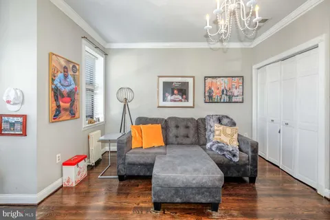 a living room with furniture and a chandelier