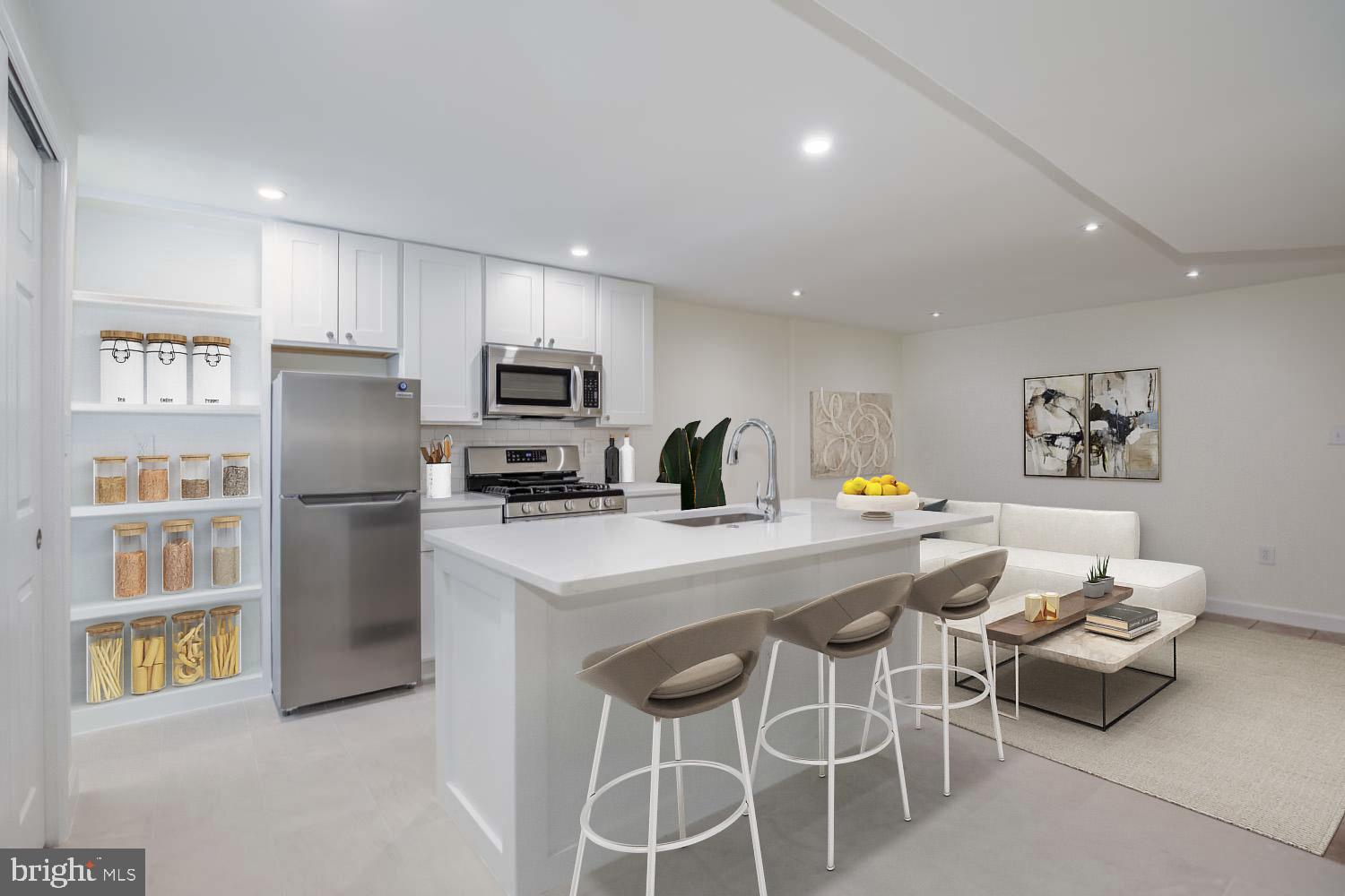 306 M Street Northwest Washington, DC 20001 - Photo 18 of 22 a kitchen with stainless steel appliances kitchen island granite countertop a refrigerator and a stove top oven