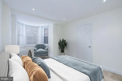 a spacious bedroom with a bed and a couch