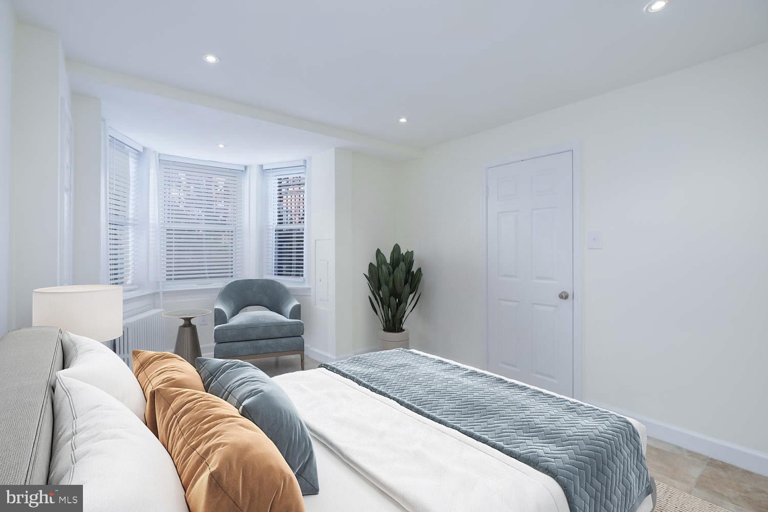 306 M Street Northwest Washington, DC 20001 - Photo 21 of 22 a spacious bedroom with a bed and a couch
