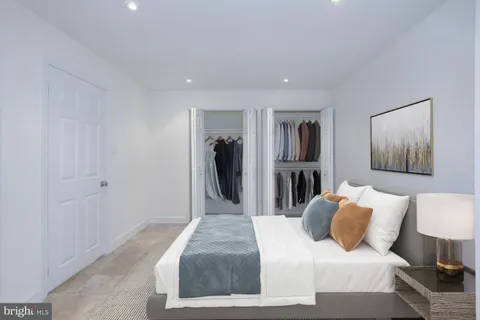 a bedroom with a bed and a painting on the wall