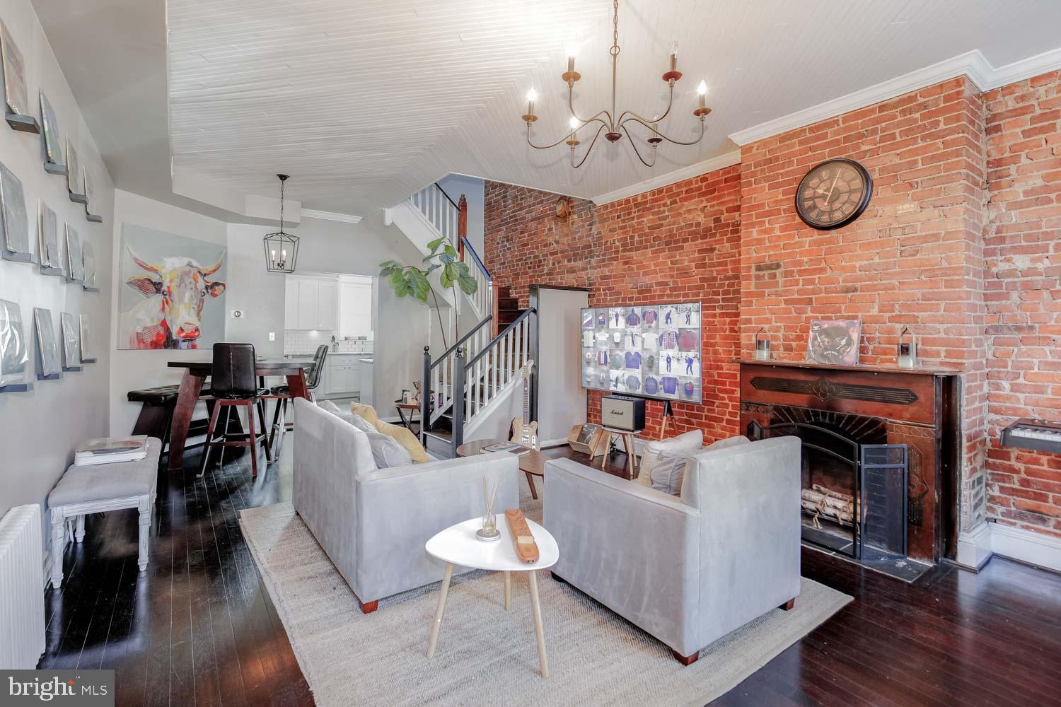 306 M Street Northwest Washington, DC 20001 - Photo 4 of 22 a living room with furniture a fireplace a clock and a large window
