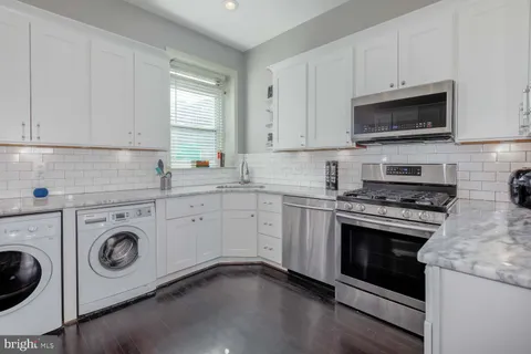 a kitchen with a stove and a microwave oven