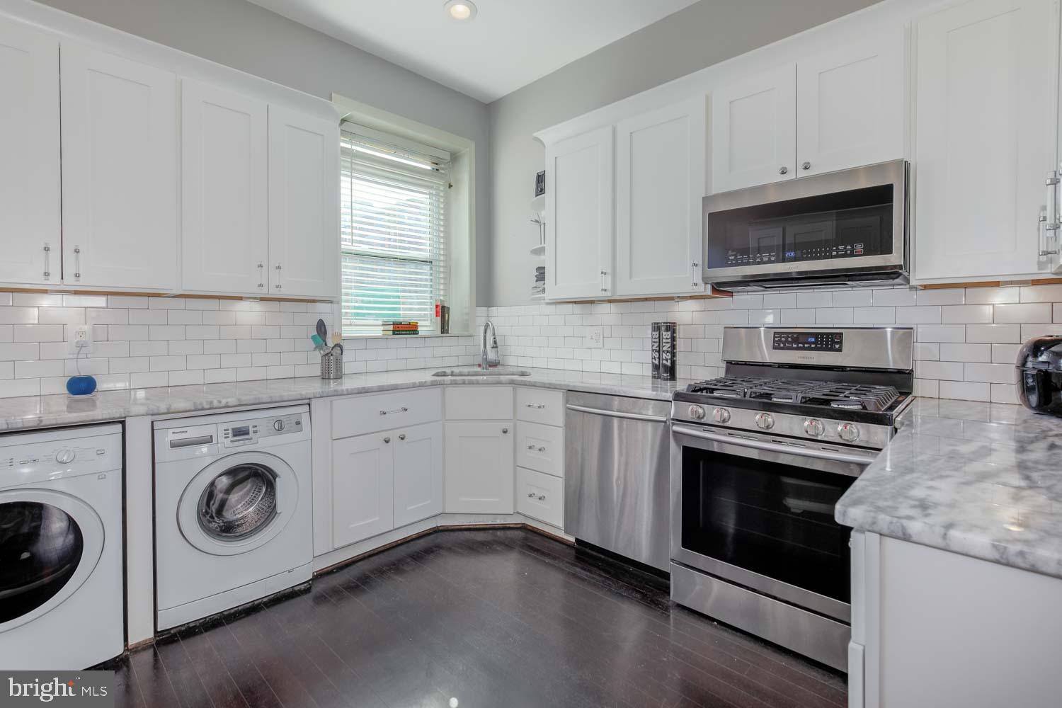 306 M Street Northwest Washington, DC 20001 - Photo 7 of 22 a kitchen with a stove and a microwave oven