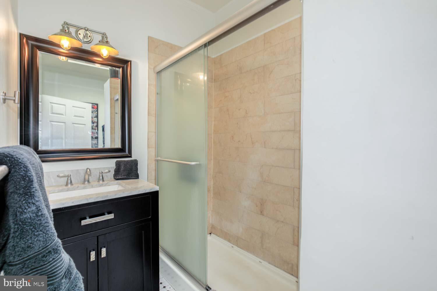 306 M Street Northwest Washington, DC 20001 - Photo 9 of 22 a bathroom with a sink a mirror and a shower