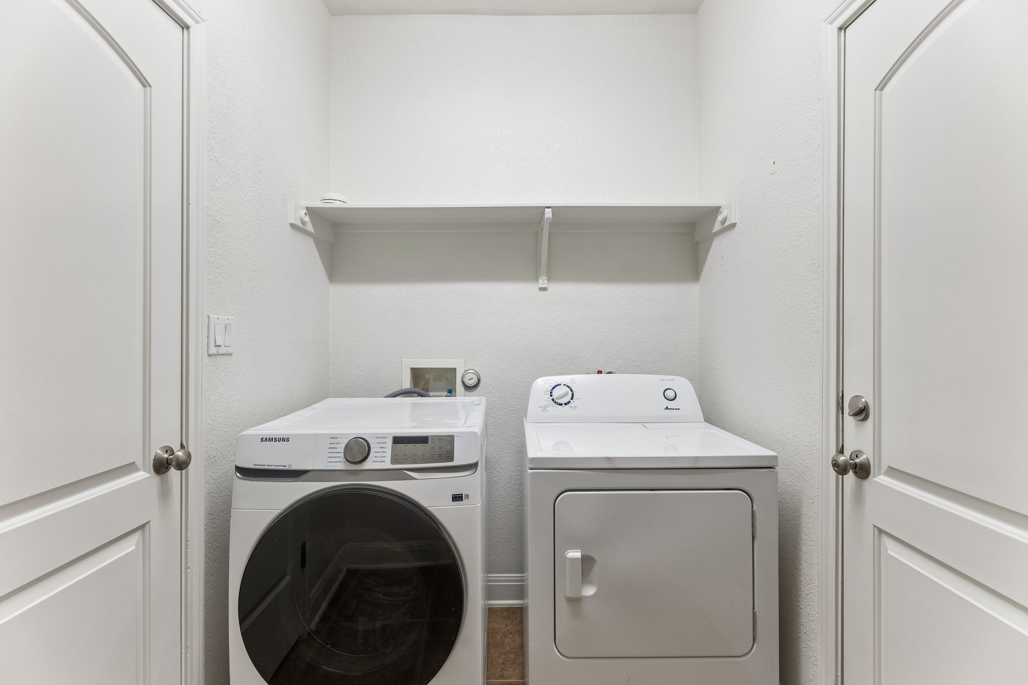 114 Aria Ridge, Unit 802 Lakeway, TX 78738 - Photo 13 of 37 Functional utility room featuring a convenient shelf for organization.