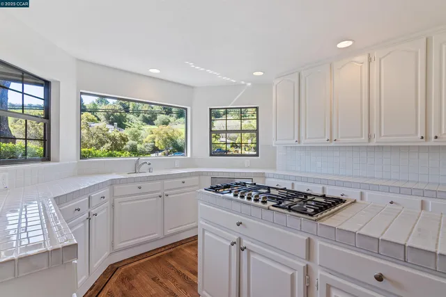 a kitchen with stainless steel appliances a refrigerator and a stove top oven