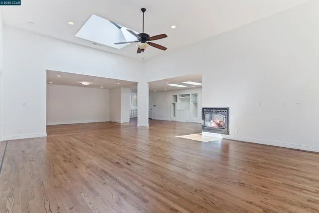 a view of empty room with wooden floor and entryway