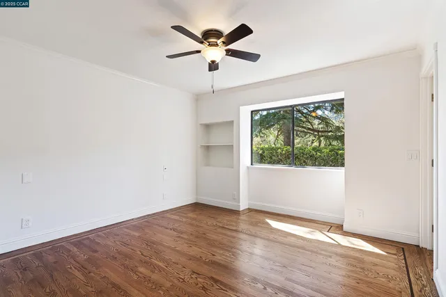a utility room with wooden floor washer and dryer