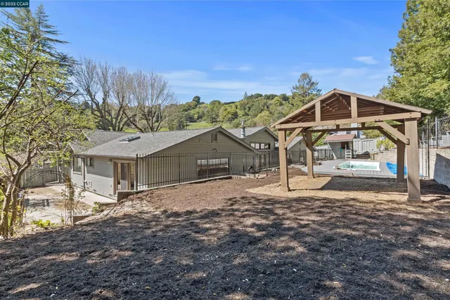 a view of a house with sitting area and swimming pool