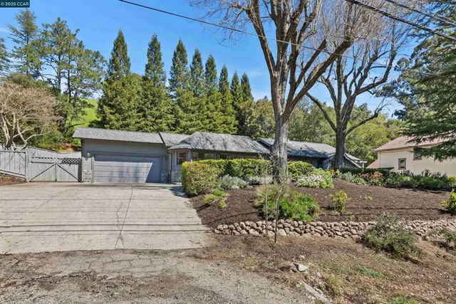 a view of a hallway with wooden floor and windows