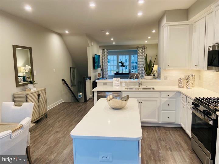 2640 Jetstream Road Herndon, VA 20171 - Photo 3 of 20 a large white kitchen with a stove a sink dishwasher and a refrigerator with wooden floor