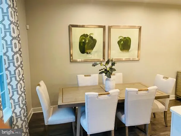 a dining room with a table and chairs