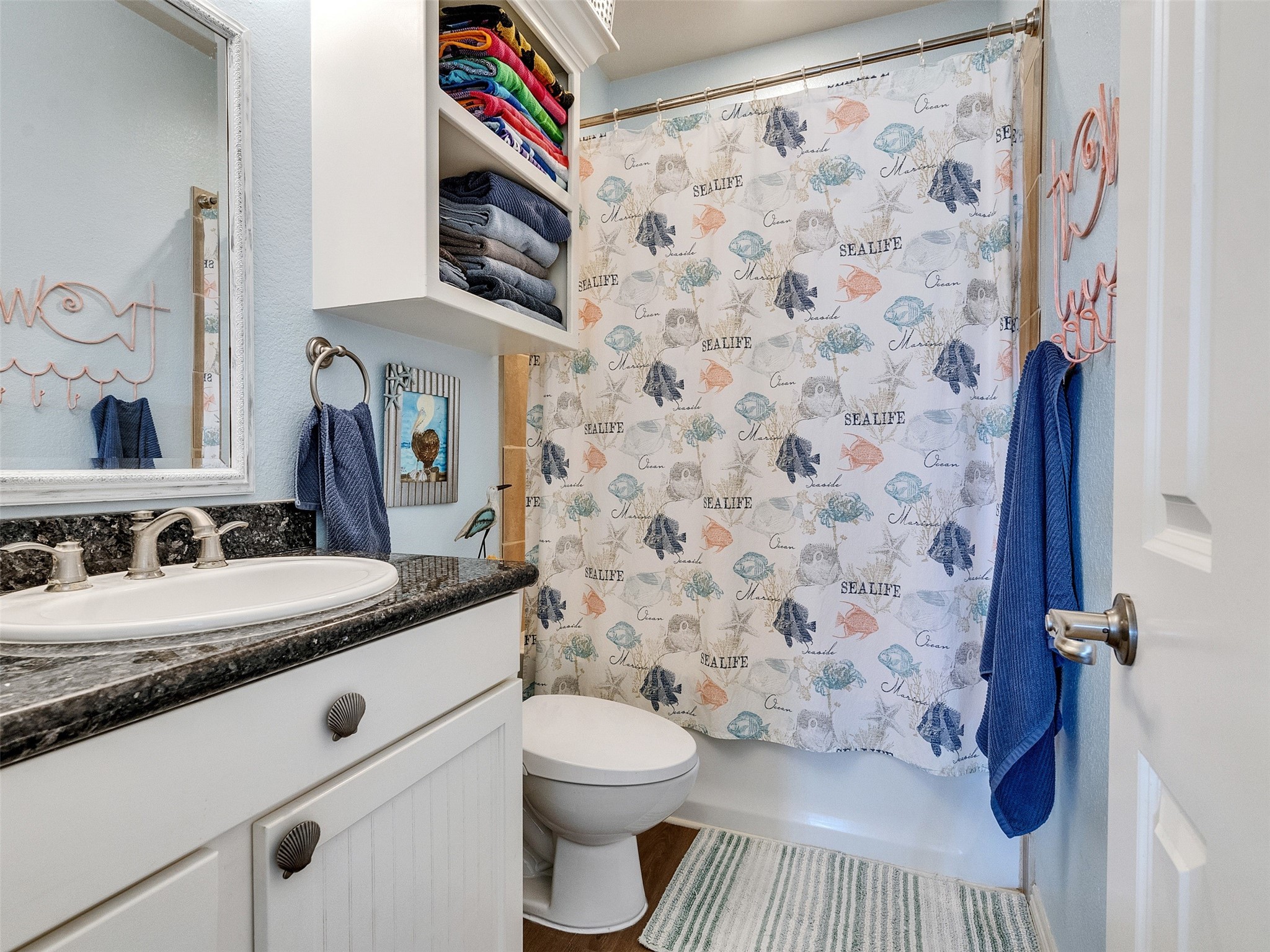 4710 Palm Street Freeport, TX 77541 - Photo 20 of 23 a bathroom with a granite countertop sink and a toilet