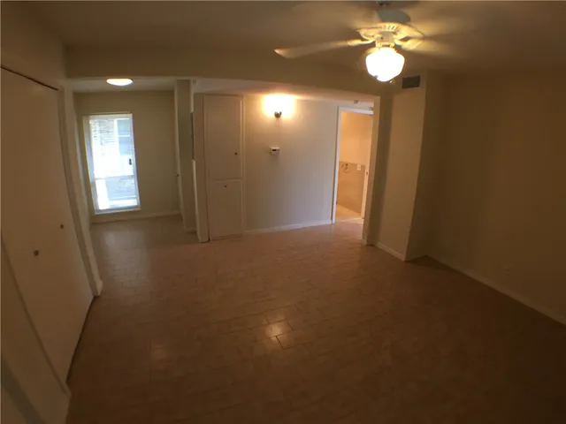 a view of an empty room with a mirror