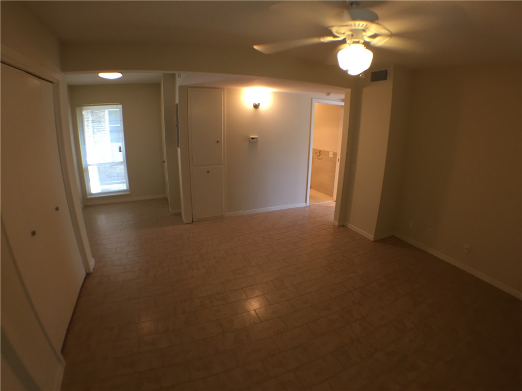 2800 Cole Street, Unit 201C Austin, TX 78705 - Photo 13 of 16 a view of an empty room with a mirror