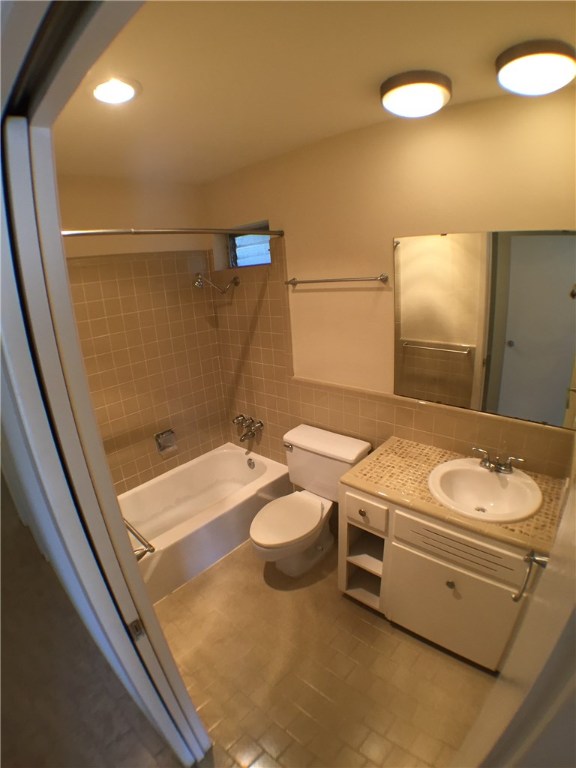2800 Cole Street, Unit 201C Austin, TX 78705 - Photo 14 of 16 a bathroom with a granite countertop sink a mirror and a toilet
