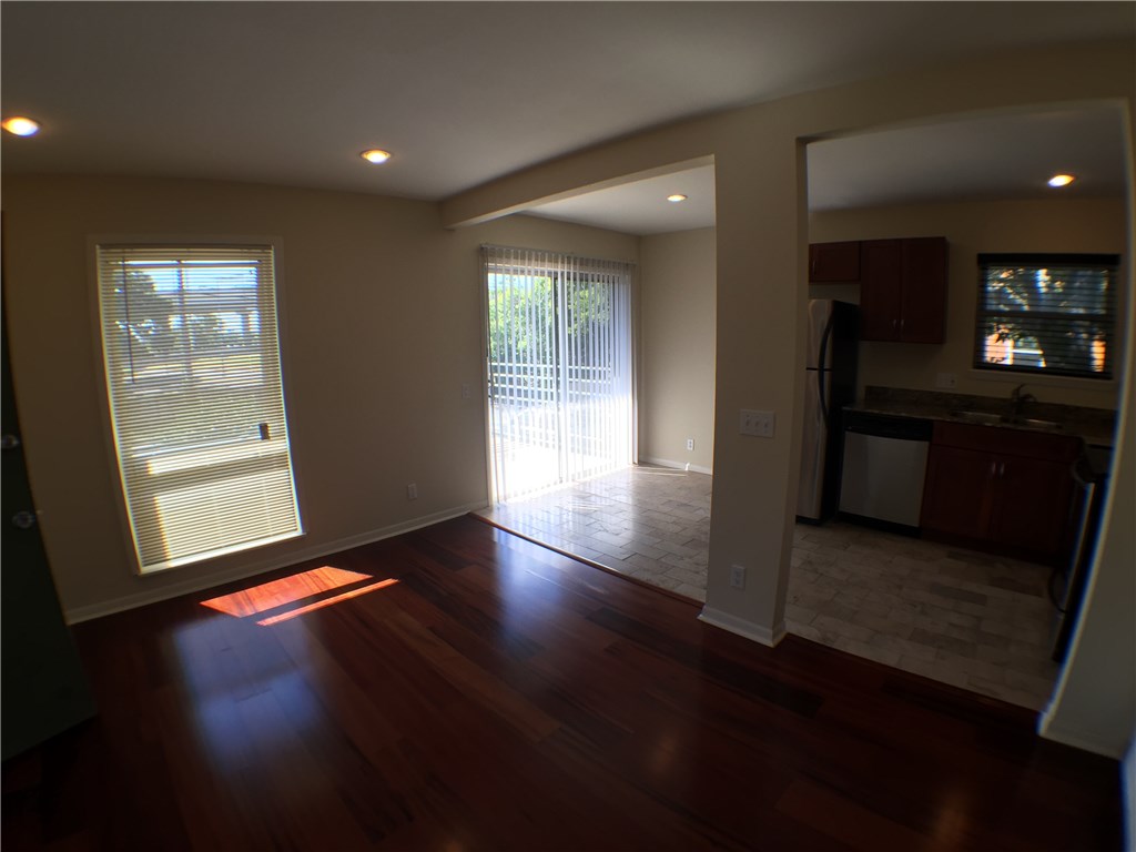 2800 Cole Street, Unit 201C Austin, TX 78705 - Photo 5 of 16 an empty room with wooden floor and windows
