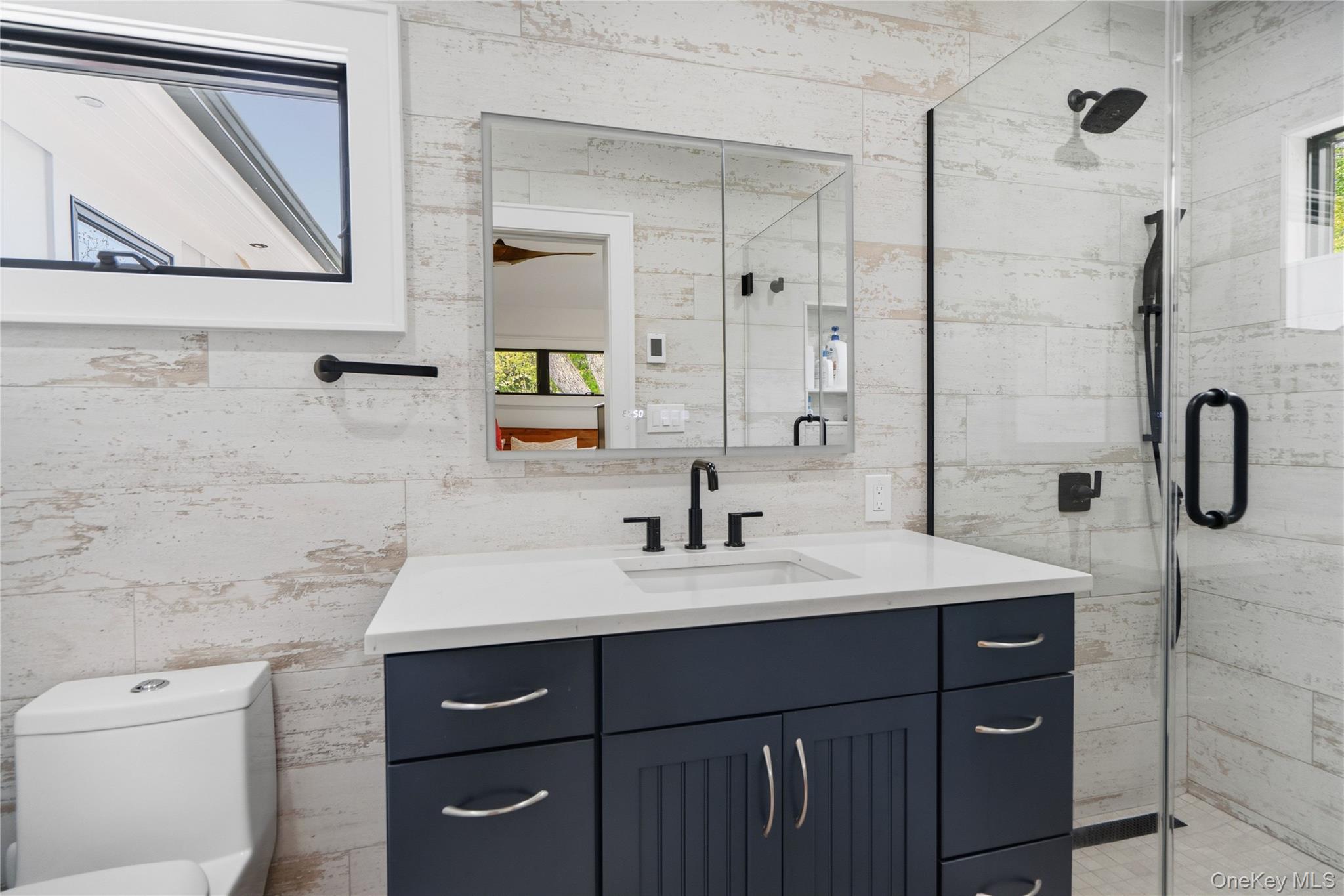 263 Beaver Dam Road Brookhaven, NY 11719 - Photo 19 of 32 a bathroom with a sink vanity toilet and shower
