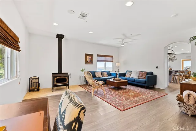 a kitchen with stainless steel appliances kitchen island granite countertop a table chairs sink and cabinets