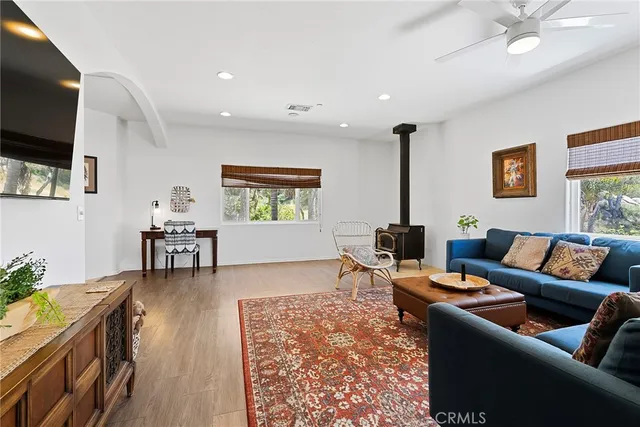 a kitchen with stainless steel appliances granite countertop a sink a stove top oven a counter space and wooden floor